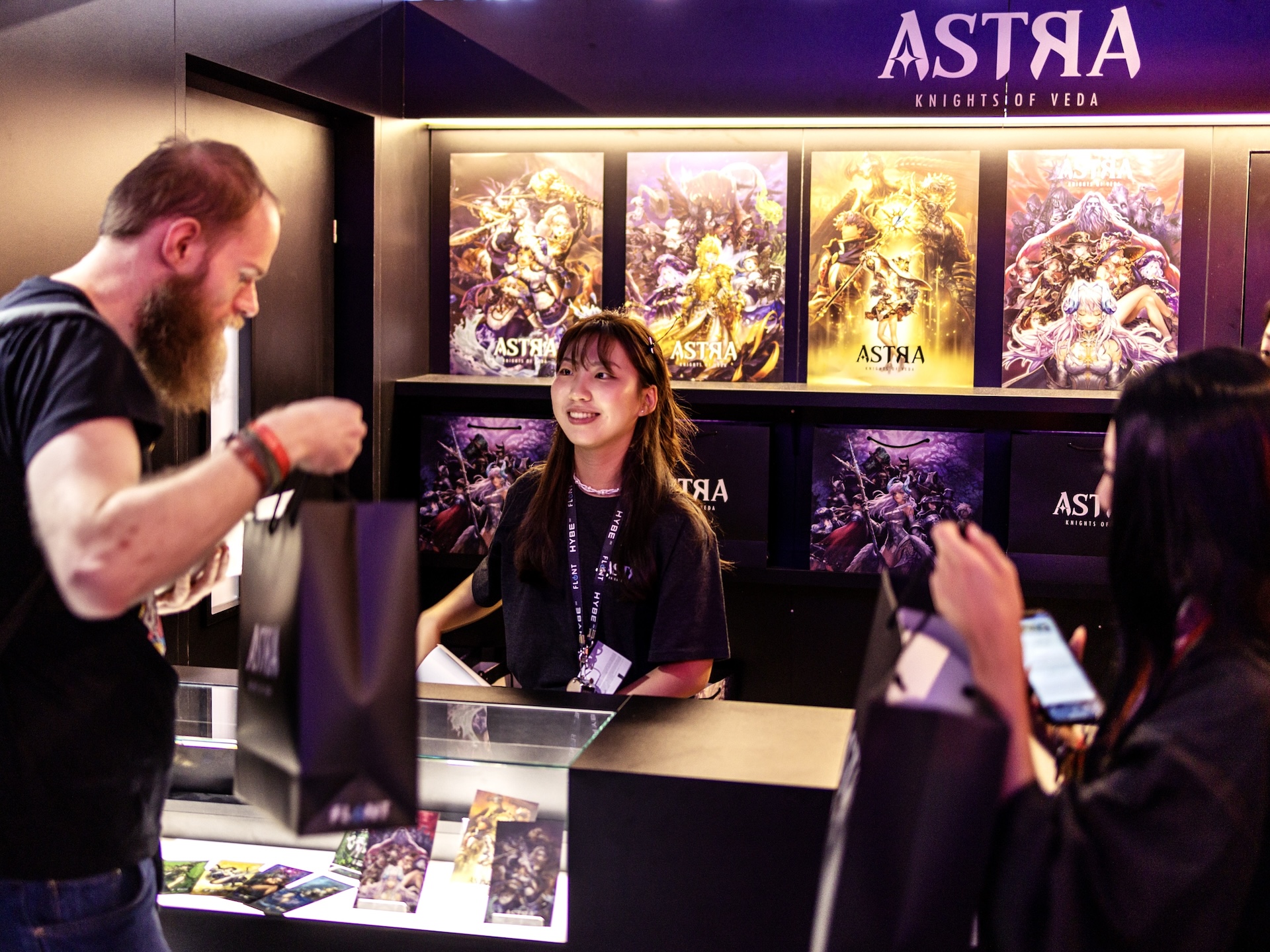 Gamescom tips for exhibitors by Gamescom agency, a guy picking up a merch bag at the front